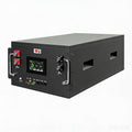 Ampulse LiFeP04 home battery storage unit front view showing LCD status display, P+ P- terminals, BMS indicator lights and hardware protection switch on white background